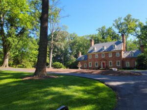 Wellspring Manor & Spa in Maryland. A brick bed and breakfast surrounded by trees.