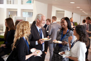 Delegates networking during conference lunch break.